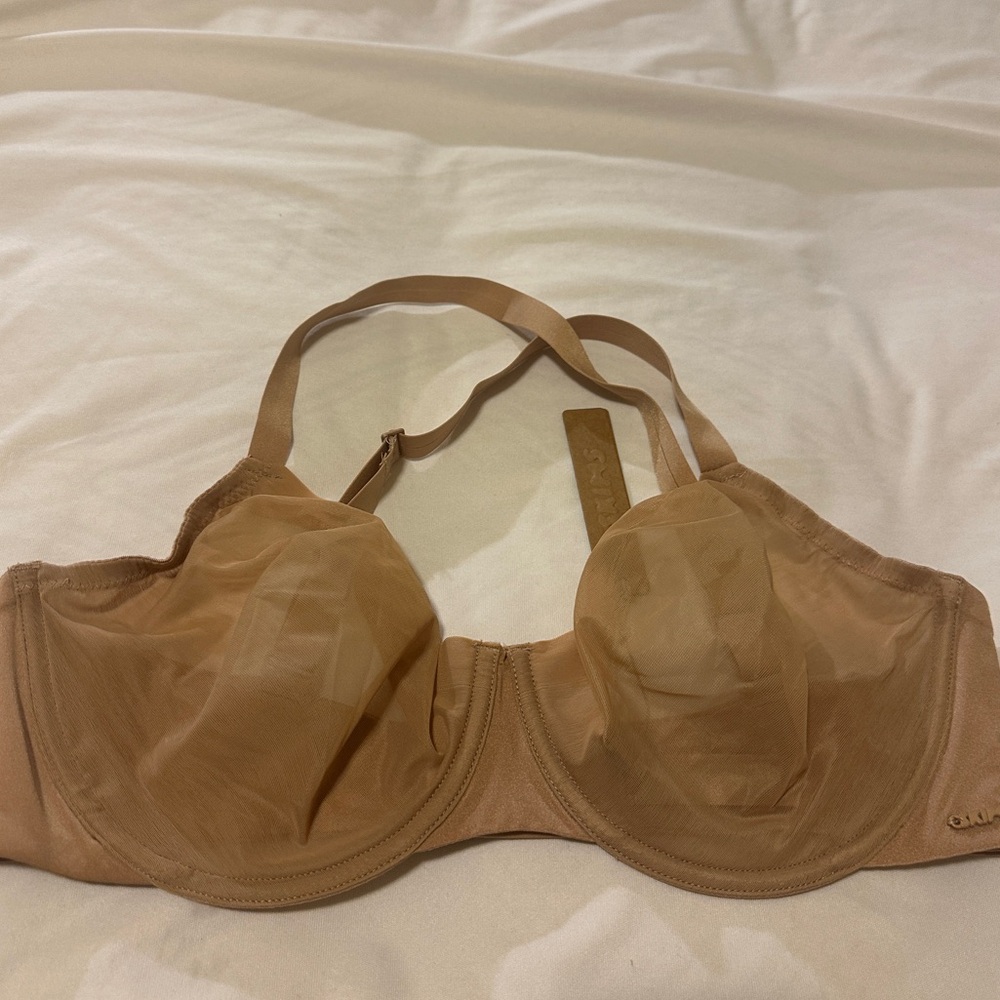 Skims No Show unlined 36dd. NWT. Straps have been re-sewn to be crossback. Tan.